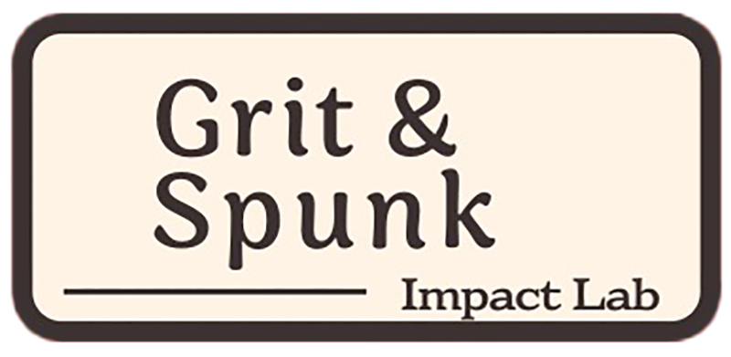 A rectangular sign with a beige background and dark border displays the text Grit & Spunk in large letters and Impact Lab in smaller letters in the lower right corner.